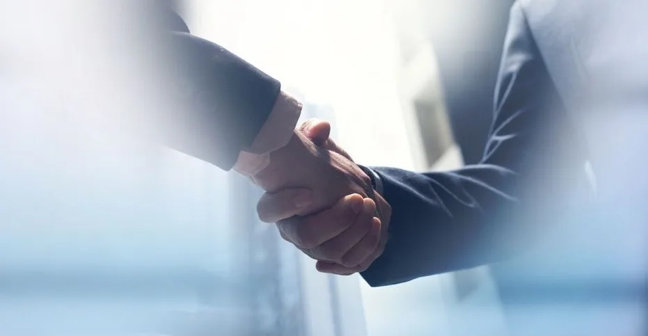 Business partnership handshake